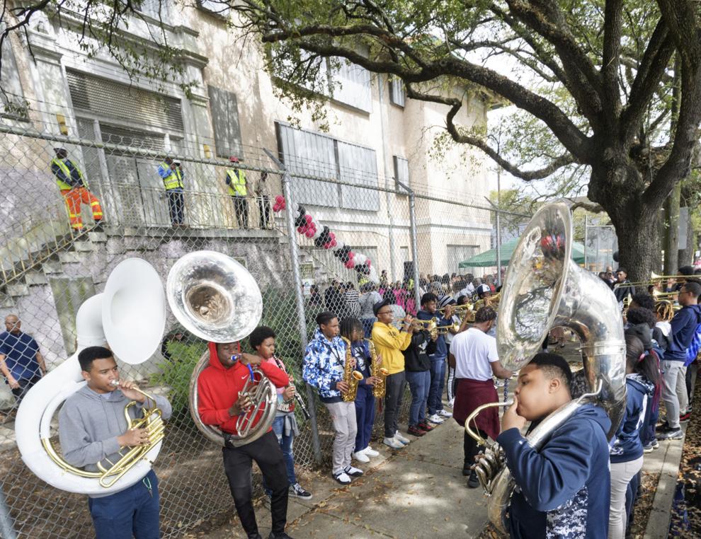 Musicians playing tubas, saxophones, and trumpets line the sidewalk outside the Tate, Etienne, and Prevost Center at its groundbreaking in 2020. Photo Credit: Nola.com