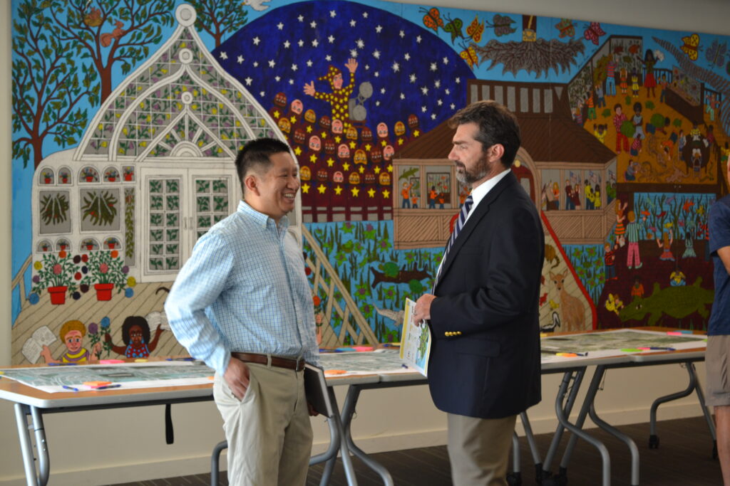 Two public meeting attendees having a conversation