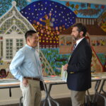 Two public meeting attendees having a conversation